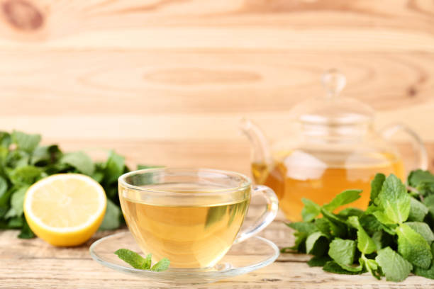 istock Cup of tea with mint leafs on wooden table 1125573350