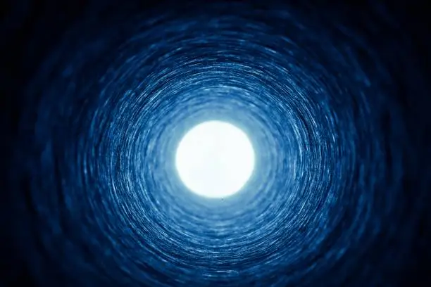 Photo of Looking down a cardboard tube towards a bright source of light