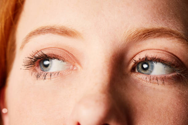 Woman's blue eyes looking dreamily to her right