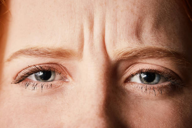 beautiful but frowning young redhead in cropped close-up - frowning imagens e fotografias de stock