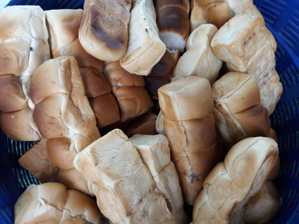 Pound bread in a basket for fish food.
