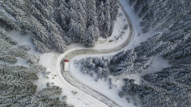 istock Meandering Winter Mountain Road with a Truck 1125583474