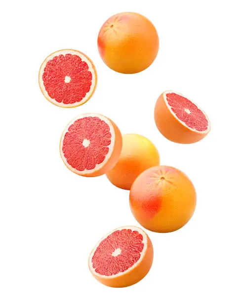 Photo of Falling grapefruits isolated on white background, clipping path, full depth of field