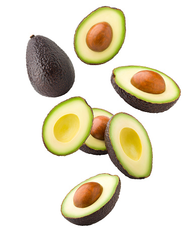 Falling avocado, clipping path, isolated on white background full depth of field