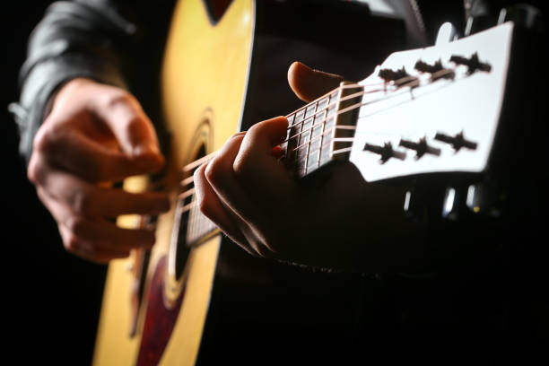 young men playing the guitar with black background - guitarist one person caucasian adult imagens e fotografias de stock