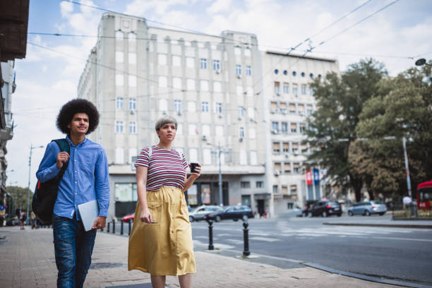 istock Students life. Students relaxing after class, walking down the street 1125589750