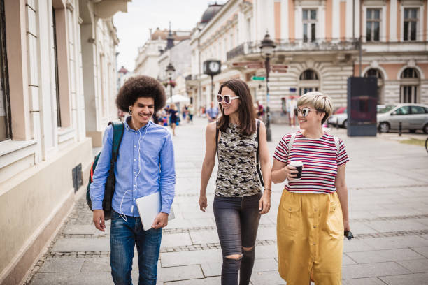 istock Students life. Students relaxing after class, walking down the street 1125589827
