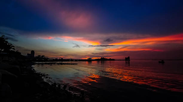 istock Dramatic sunset sky at sea with silhouette of island background 1125590352