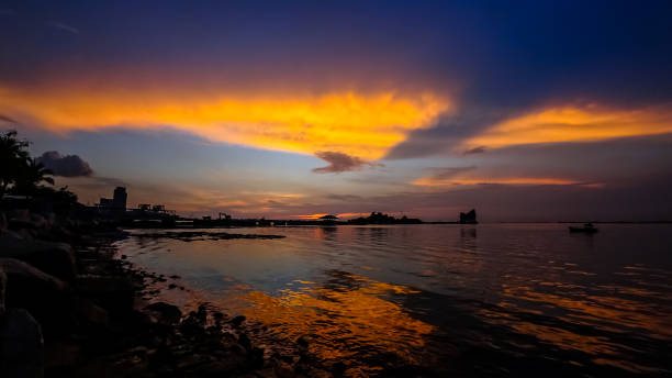 istock Dramatic sunset sky at sea with silhouette of island background 1125590371