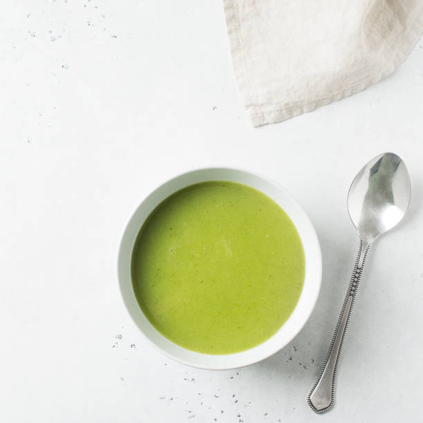 istock Green vegetable soup on white background minimalism 1125590682