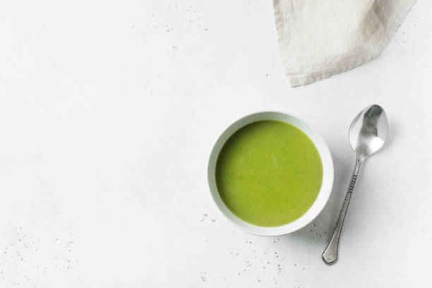 istock Green vegetable soup on white background minimalism 1125590687