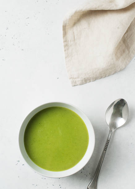 istock Green vegetable soup on white background minimalism 1125590696