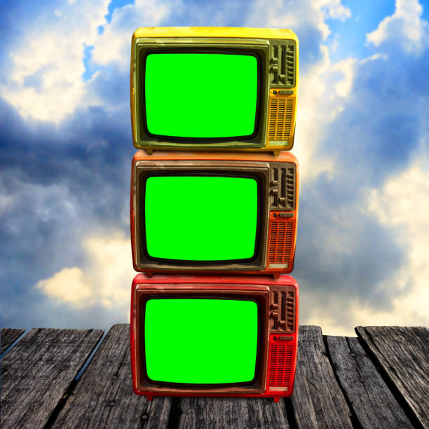 istock Retro television with green screen on wooden deck with clouds sky background 1125590729