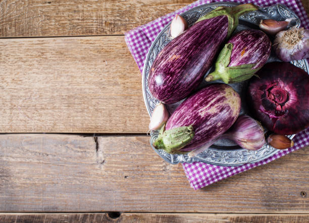 istock Some eggplants, garlic and red onion on a bowl 1125591621
