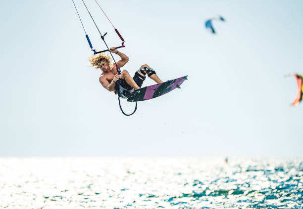 istock Young man flying with kiteboard above the sea. 1125591629