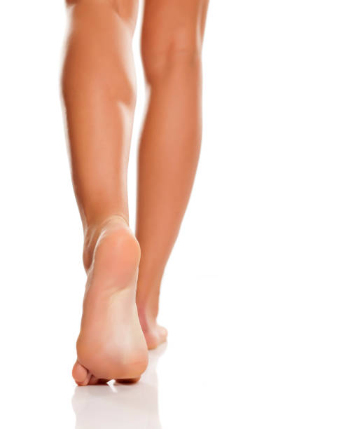 istock Beautiful woman legs and feet on white background 1125593632