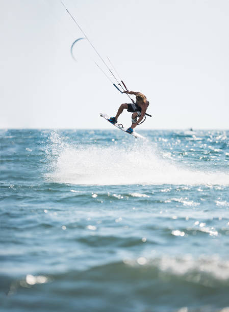 istock Athletic man having fun while kitesurfing on the sea. 1125593987