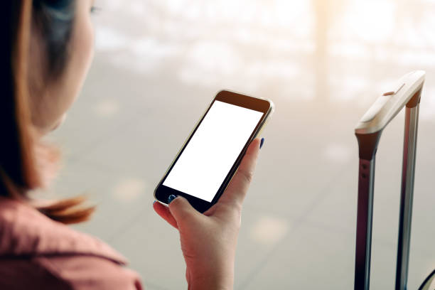 istock Asian tourist woman hands holding and using smartphone with blank screen waiting for flight in airport lounge. 1125594068