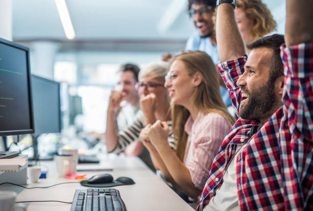istock Joyful team of programmers celebrating their success in the office. 1125597652