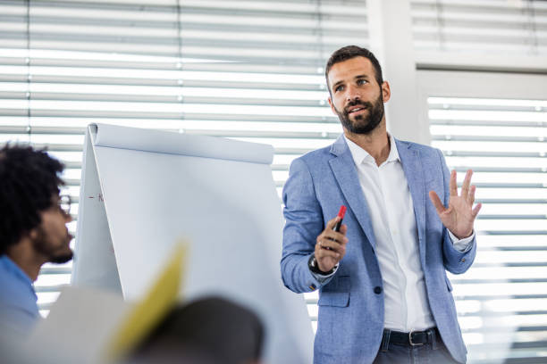Young manager talking on a business presentation in a board room.