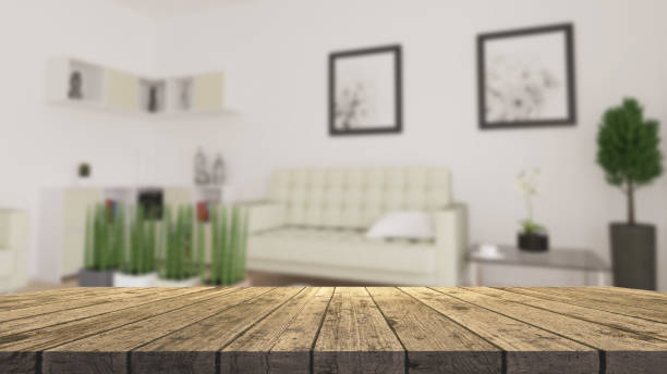 istock 3D wooden table looking out to a defocussed modern living room 1125602018