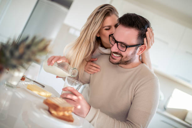 istock Young happy couple  in modern apartment having breakfast 1125602371