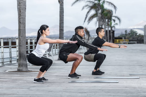 istock Athletes squatting on embankment 1125602524