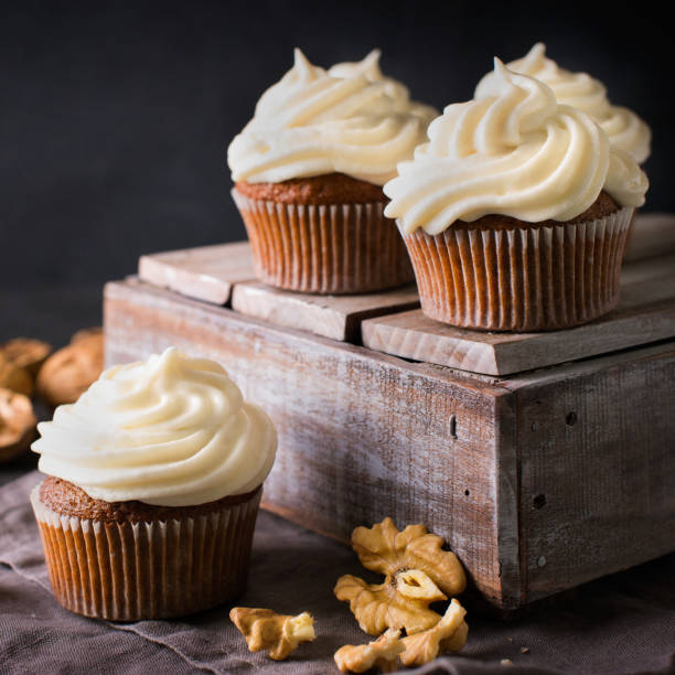 istock Carrot cupcakes or muffins with nuts on dark background 1125602608