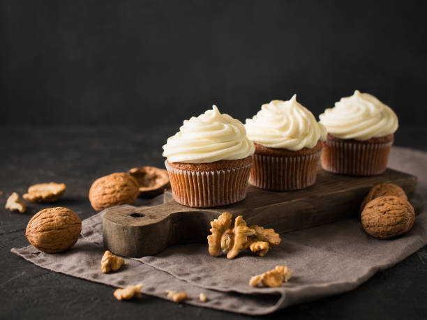 istock Carrot cupcakes or muffins with nuts on dark background 1125602637