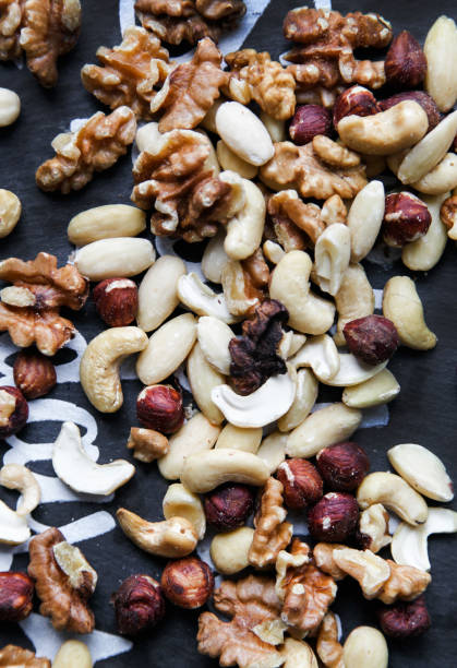 istock Natural background made in nuts. Hazelnut, walnut and cashew background. 1125606877