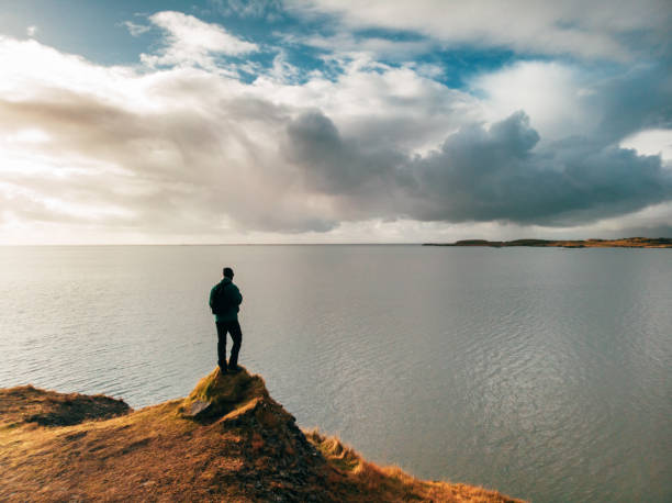 Man looking and celebrating sunrise and landscape