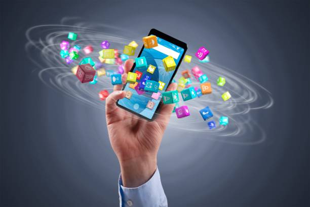 istock businessman holding a smartphone with icon cubes 1125607659