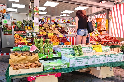 People visit vegetable market in Nuremberg, Germany. Nuremberg is located in Middle Franconia. 511,628 people live here.