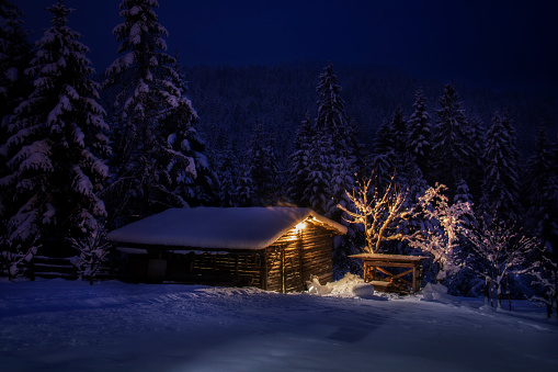Winter night in the mountain - Hut covered with snow
