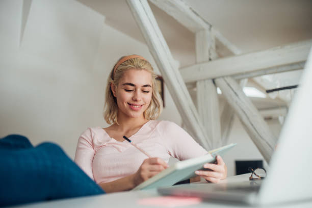 istock Woman writing and smiling 1125612807