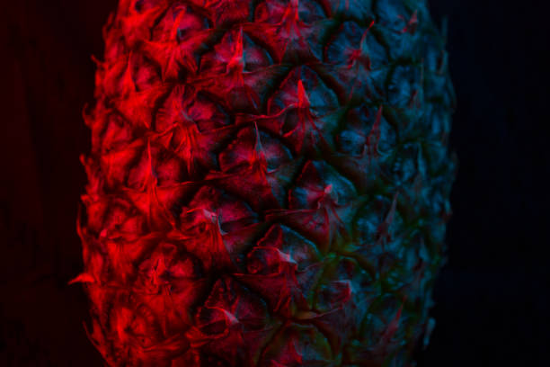 Close up texture of fresh ripe pineapple in neon light
