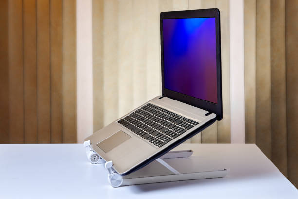 istock Aluminum alloy foldable notebook stand holder with laptop on desk. 1125614848