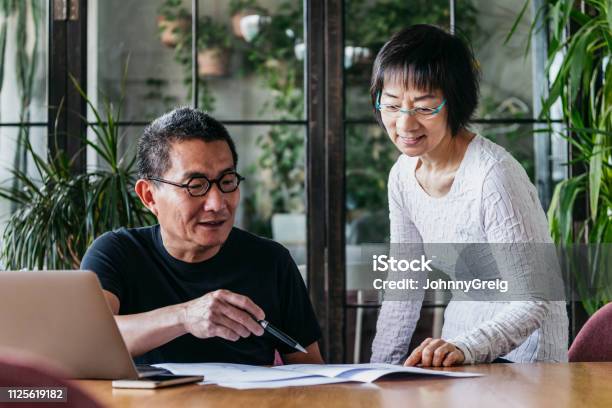 Mature Man And Senior Woman Looking At Home Finances With Laptop Stock Photo - Download Image Now