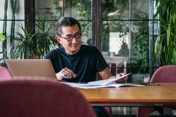 istock Mature Chinese man working from home on laptop 1125619190