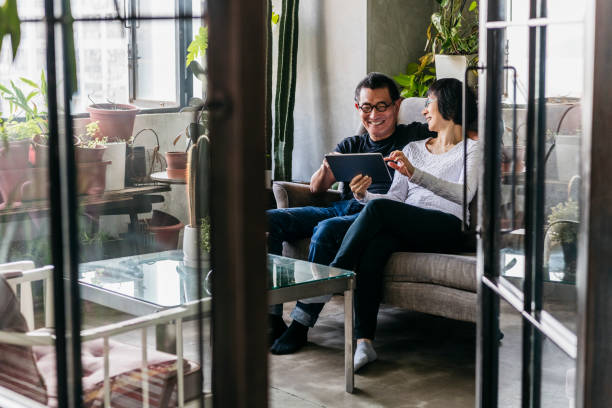 istock Cheerful Chinese couple using tablet in modern Chinese apartment 1125619208