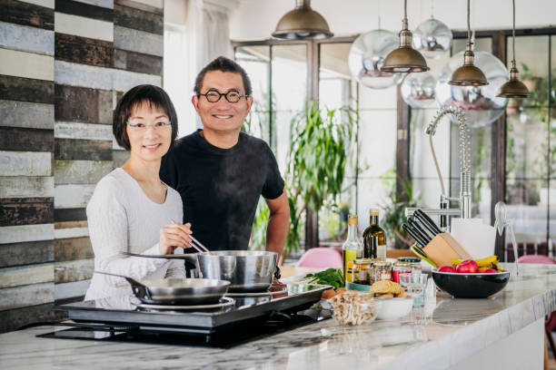 istock Senior woman making dinner with mature man helping 1125619250