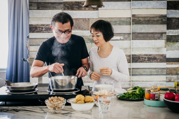 istock Chinese couple making dinner together in kitchen 1125619254