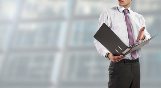 istock Business man consults folders in a binder 1125619398