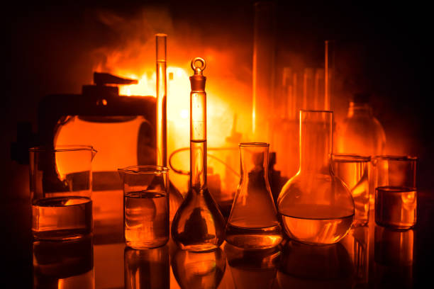 istock Pharmacy and chemistry theme. Test glass flask with solution in research laboratory. Science and medical background. Laboratory test tubes on dark toned background 1125625470