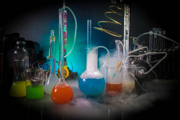 istock Pharmacy and chemistry theme. Test glass flask with solution in research laboratory. Science and medical background. Laboratory test tubes on dark toned background 1125625486