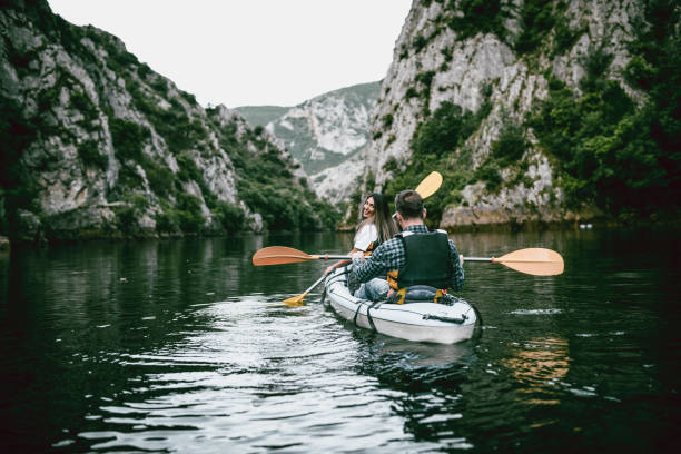 istock Young Couple Kayaking Towards Canyon's End 1125630340