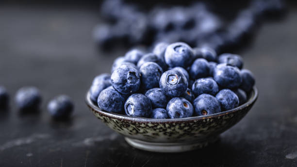 istock Juicy and fresh blueberries on a beautiful background in a bowl 1125630556