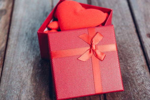 istock Fabric red heart and gift box on wooden background 1125630612