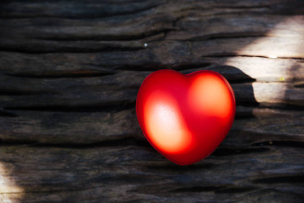 istock Red heart love on wooden background 1125630785