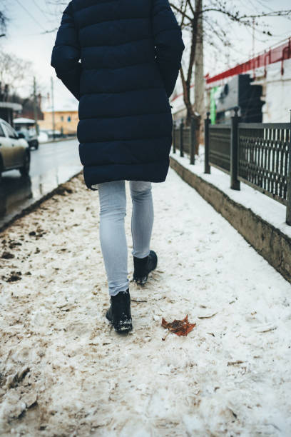 istock Back view young woman wearing winter coat 1125631743